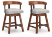 Ralene - Upholstered Swivel Barstool (Set of 2) - Medium Brown Signature Design by Ashley®