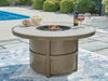 Rainier Ranch - Round Fire Pit Table - Beige Signature Design by Ashley®
