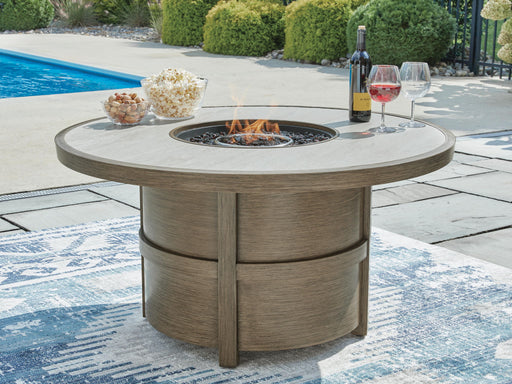 Rainier Ranch - Round Fire Pit Table - Beige Signature Design by Ashley®
