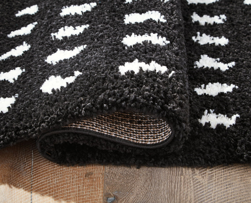 Minston - 5' x 7' Rug - Black / White Signature Design by Ashley®
